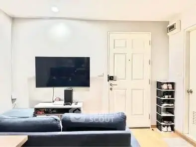 Modern living room with sleek TV setup and cozy seating area