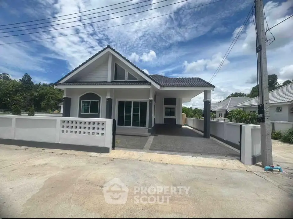 Charming single-story house with modern design and spacious driveway in a serene neighborhood.