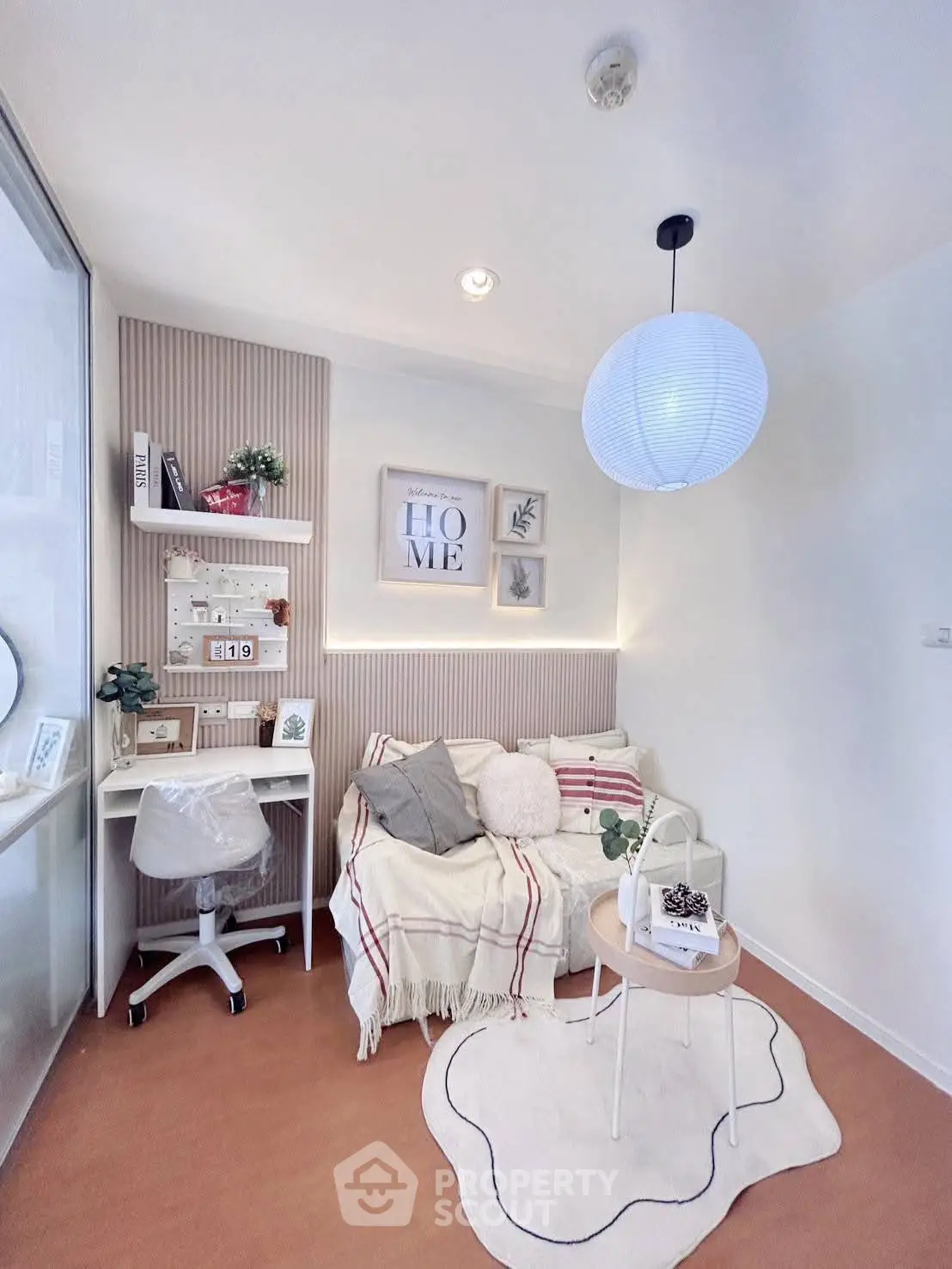 Cozy study nook with modern decor and comfortable seating in a stylish apartment.