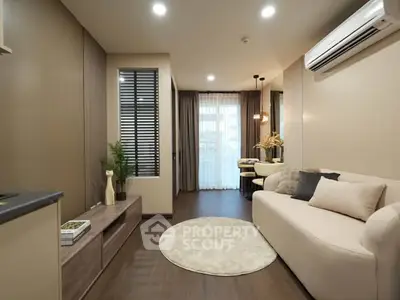Modern living room with elegant decor and natural light, featuring a cozy sofa and stylish furnishings.