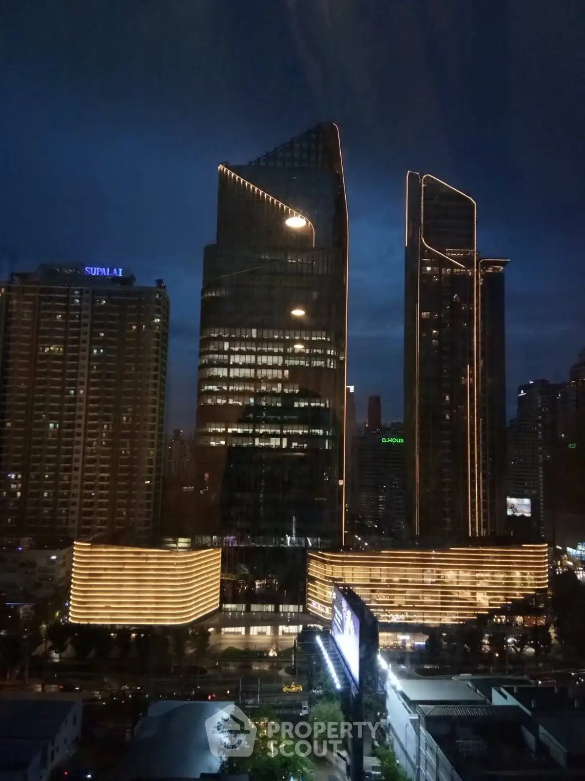 Stunning night view of modern skyscrapers with illuminated architecture in urban cityscape.