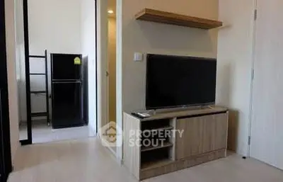 Modern living room with sleek TV stand and adjacent kitchen area