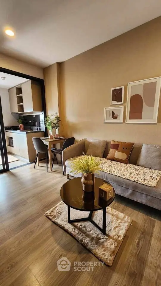 Modern living room with cozy sofa, stylish decor, and open kitchen layout in a contemporary apartment.