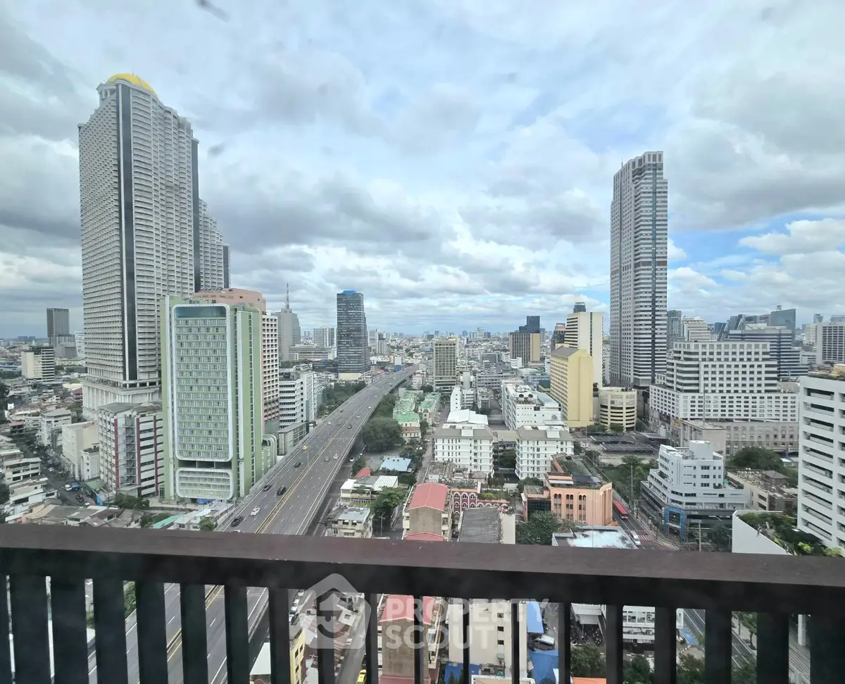 Stunning cityscape view from a high-rise balcony showcasing urban skyline and vibrant city life.