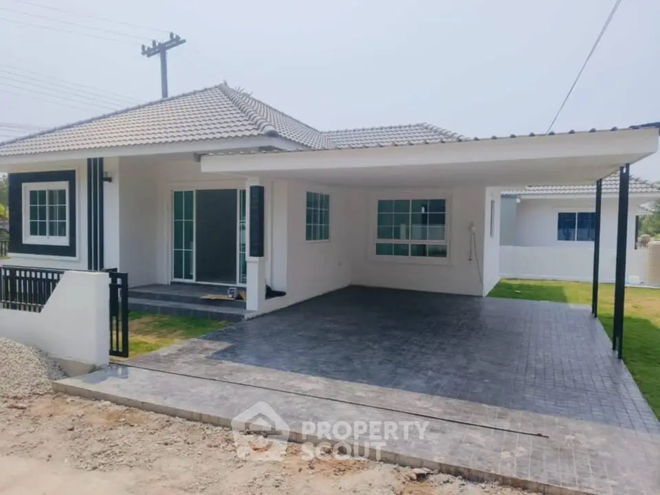 Charming single-story home with spacious carport and modern exterior design.