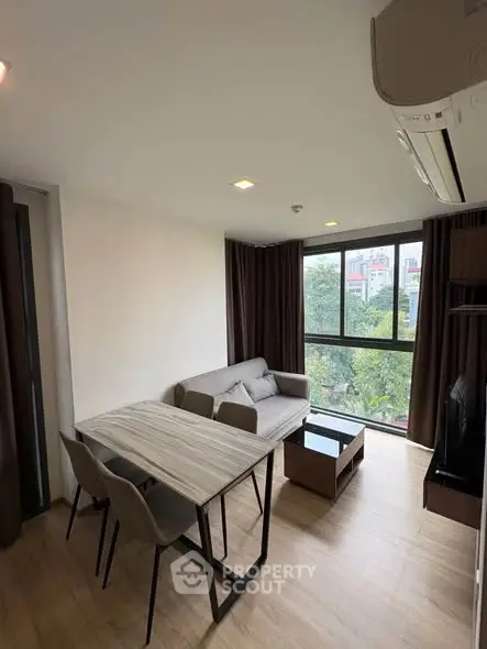 Modern living room with large windows and stylish furniture in a cozy apartment.