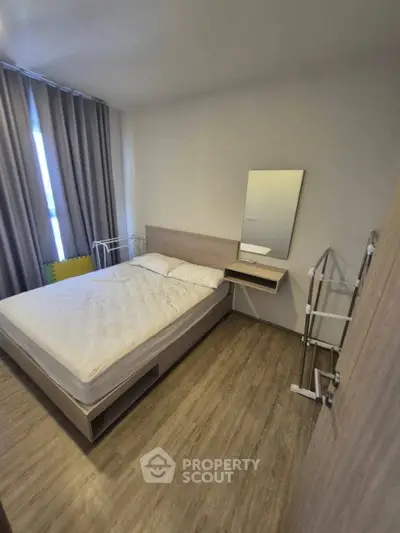 Cozy bedroom with modern furnishings and natural light