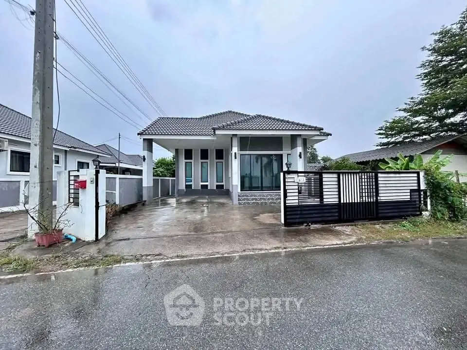 Charming single-story house with modern design and spacious driveway in a serene neighborhood.
