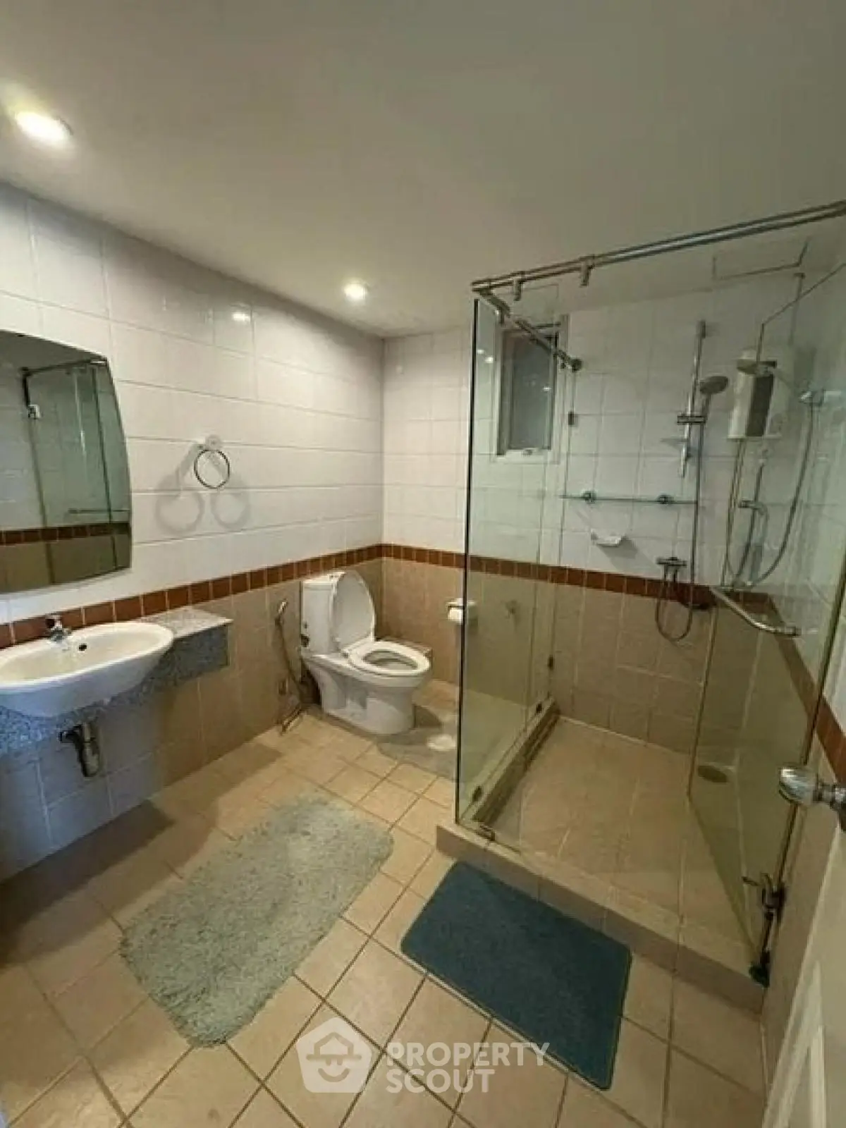 Spacious bathroom with modern shower and sleek fixtures in a contemporary home.