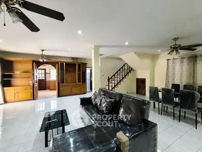 Spacious living room with modern furniture and open layout, ideal for family gatherings.