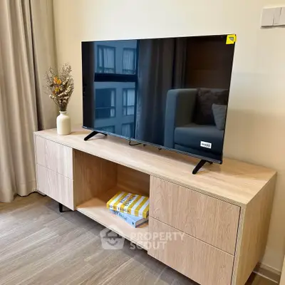 Modern living room with sleek TV on wooden console and elegant decor