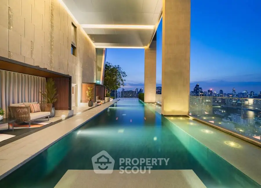 Luxurious rooftop pool with stunning city skyline view at sunset.