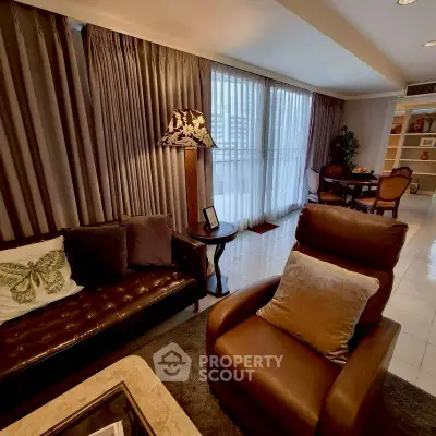 Luxurious living room with elegant decor and large windows in a modern apartment.