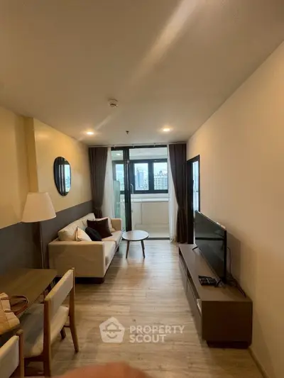 Modern living room with stylish decor and city view from large windows.