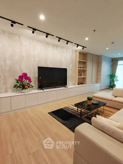 Spacious modern living room with elegant decor and large TV setup