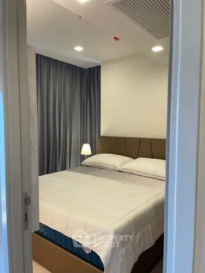 Cozy bedroom with modern decor and ambient lighting, perfect for relaxation.