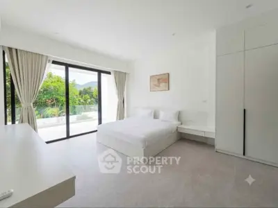 Spacious modern bedroom with large windows and scenic view