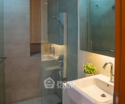 Modern bathroom with glass shower and sleek sink design