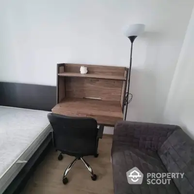 Cozy study nook with desk, chair, and lamp in modern apartment