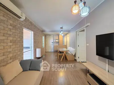 Modern living room with stylish decor and open layout, featuring cozy seating and ambient lighting.