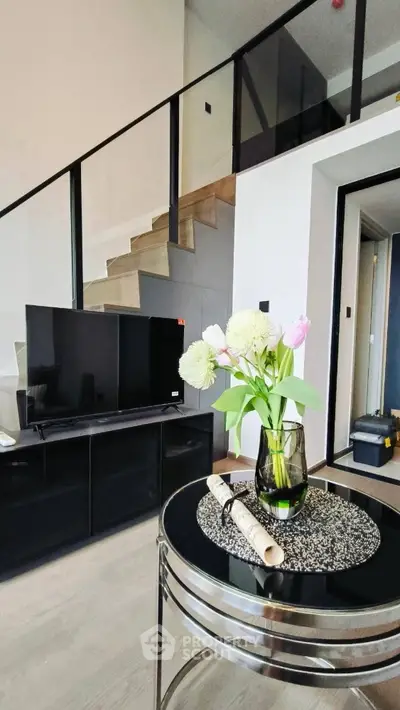 Modern living room with stylish decor and staircase in a contemporary apartment