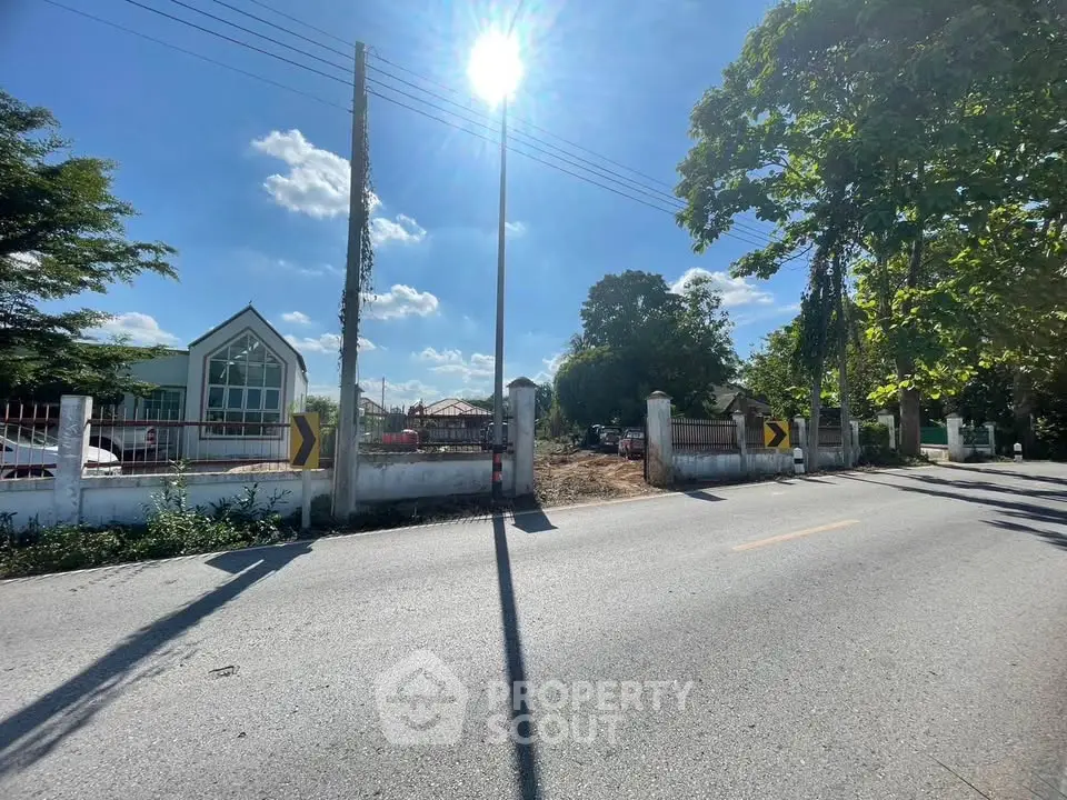 Charming suburban property with lush greenery and clear blue skies, perfect for serene living.