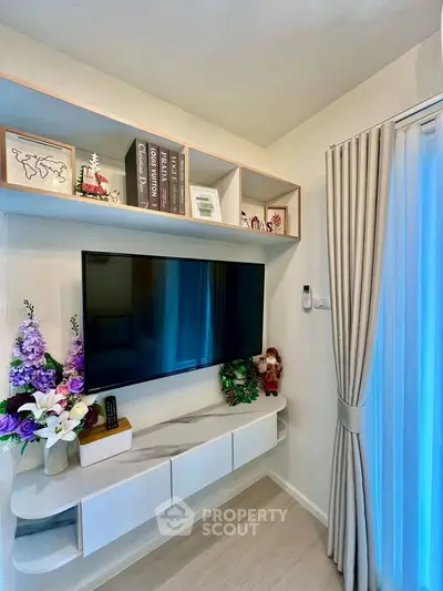 Stylish living room corner with wall-mounted TV and elegant shelving