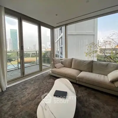 Luxurious corner living room with panoramic city views and modern furnishings.