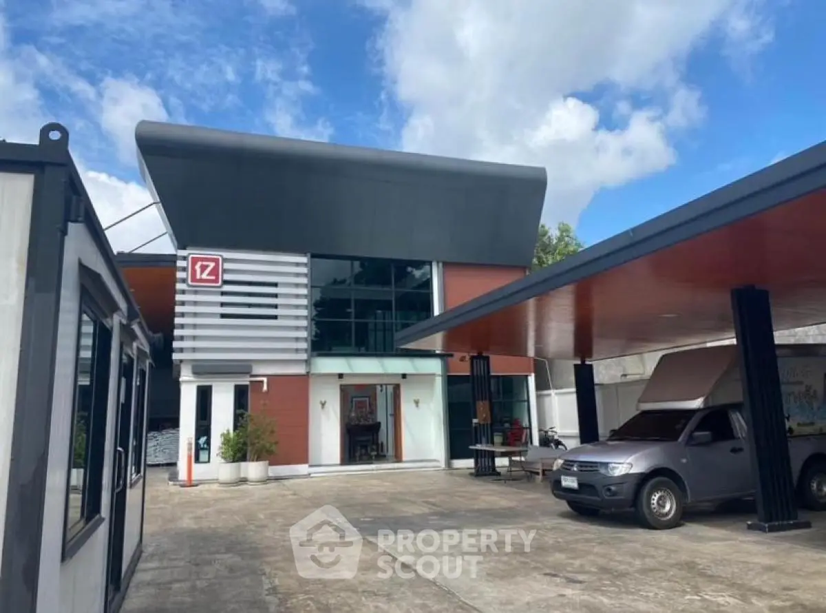 Modern commercial building with sleek design and ample parking space