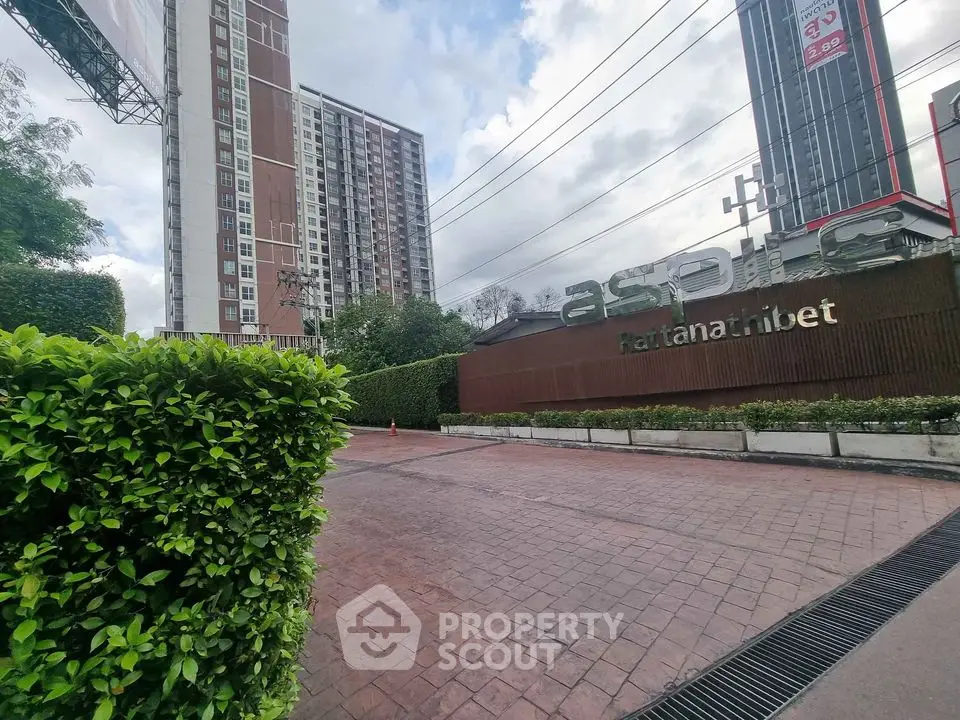 Modern condominium exterior with lush greenery and spacious entrance