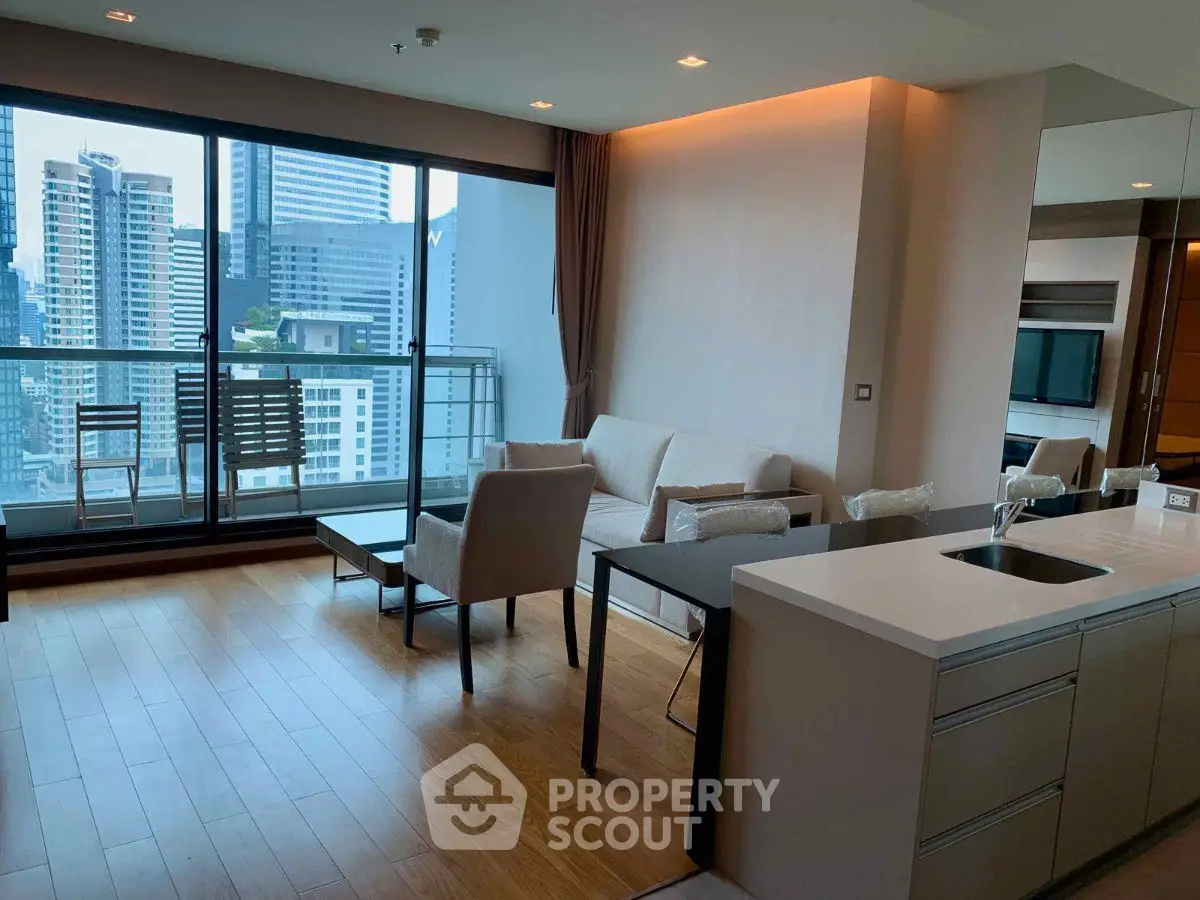 Modern living room with city view and open kitchen in luxury apartment.
