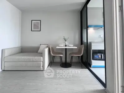 Modern open-plan living room with cozy dining area and sleek kitchen