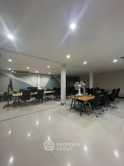 Spacious modern office space with sleek furniture and ample lighting.