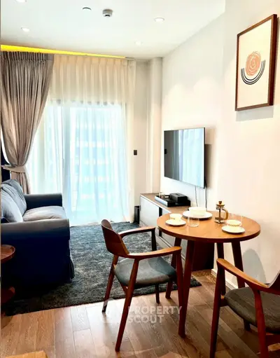 Modern living room with stylish furniture and natural light, perfect for cozy gatherings.