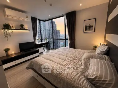 Modern bedroom with city view, stylish decor, and cozy ambiance in high-rise apartment.
