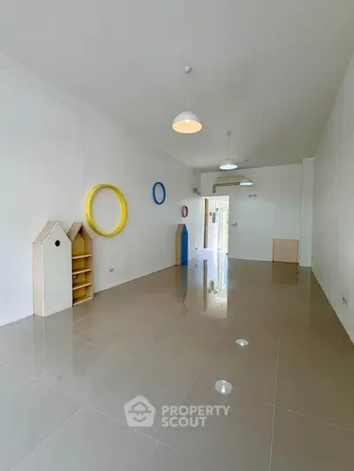 Spacious minimalist living room with modern decor and glossy tiled floor, perfect for contemporary living.