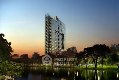 Stunning high-rise building with serene lakeside view at sunset, perfect for luxury urban living.