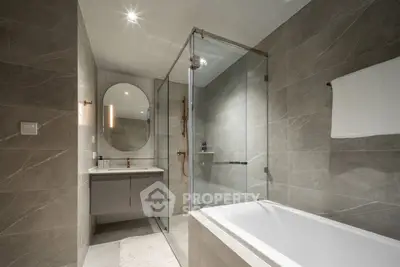 Luxurious modern bathroom with elegant fixtures and spacious shower area.