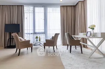 Elegant living room with modern furniture and large windows for natural light.