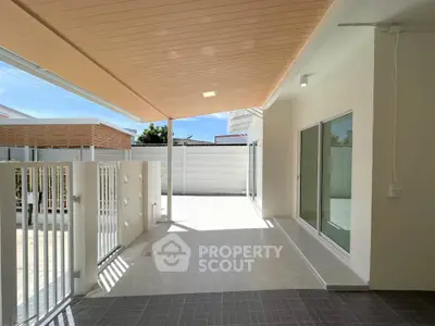 Modern covered patio with sleek design and ample natural light, perfect for outdoor relaxation.
