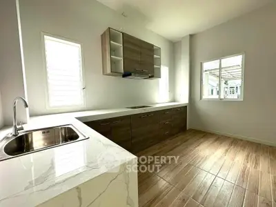 Modern kitchen with sleek cabinetry and marble countertops in a bright, spacious layout.