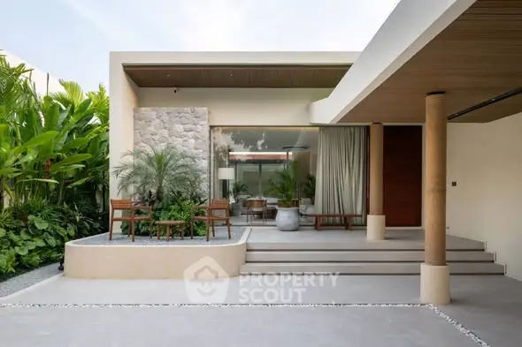 Modern home exterior with lush garden and stylish patio furniture.