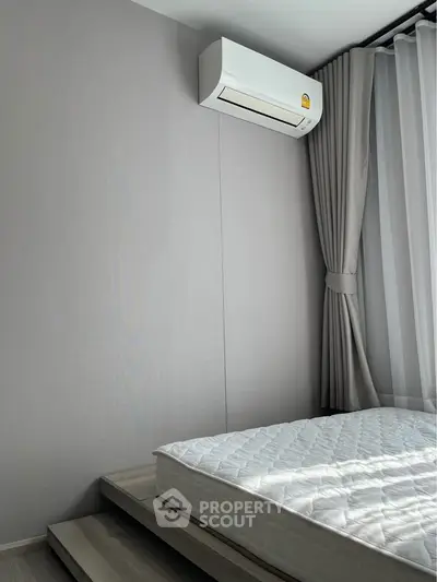 Modern minimalist bedroom with air conditioning and natural light