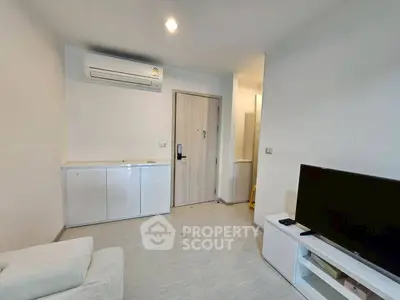 Modern living room with sleek design, featuring air conditioning and a flat-screen TV for ultimate comfort.