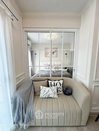 Chic living room with elegant sofa and mirrored wall for spacious feel