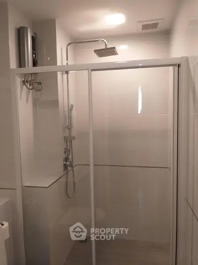 Modern bathroom with glass shower enclosure and overhead showerhead