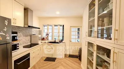 Charming kitchen with closed layout, modern appliances, and elegant cabinetry in a cozy home setting.