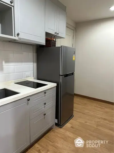 Modern kitchen with sleek fridge and stylish cabinetry