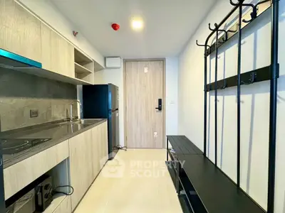 Modern kitchen with sleek cabinetry and compact appliances in a stylish apartment.