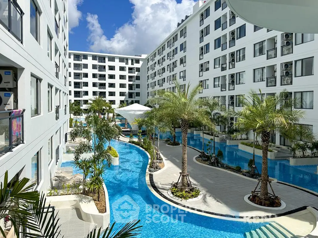 Luxurious apartment complex with stunning pool and palm trees, perfect for resort-style living.